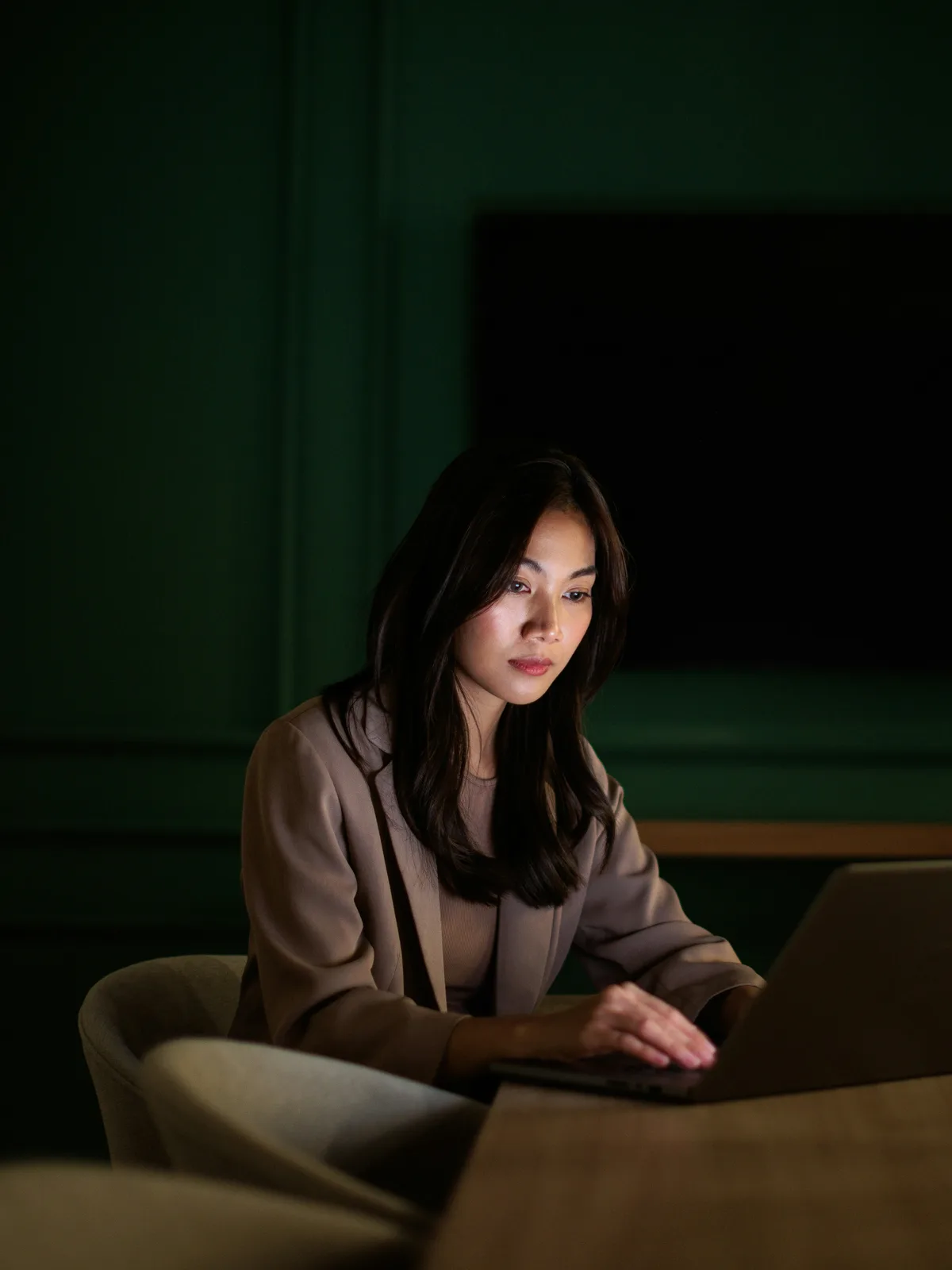A woman working late at a laptop